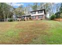 Well-maintained split-level home surrounded by mature trees and expansive lawn at 753 Brookwood Sw Ter, Lilburn, GA 30047
