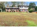 Charming split-level home featuring a well-maintained lawn and classic brick and siding design at 753 Brookwood Sw Ter, Lilburn, GA 30047