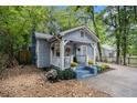 Quaint blue home with inviting front porch, lush landscaping, and well-maintained yard at 1812 Defoor Nw Ave, Atlanta, GA 30318