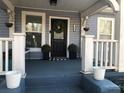 Charming front porch view with a decorated door and beautiful potted plants at 1812 Defoor Nw Ave, Atlanta, GA 30318