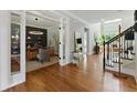 Inviting home foyer with hardwood floors, elegant staircase and an adjacent office space at 3990 Old Spring House Ct, Atlanta, GA 30338