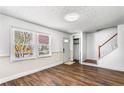 Bright living room with hardwood floors, staircase, and large windows providing ample natural light at 8827 Applegate Ln, Atlanta, GA 30350