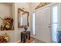 Elegant foyer with a decorative mirror and accent table, showcasing the home's style at 1152 Simonton Glen Way, Lawrenceville, GA 30045