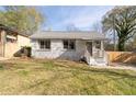 Quaint cottage-style house with stone facade and a cozy front porch entrance with light colored wood at 1441 Ezra Church Nw Dr, Atlanta, GA 30314