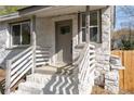 Close-up of the home's inviting front porch entrance with freshly painted steps and stone exterior at 1441 Ezra Church Nw Dr, Atlanta, GA 30314