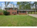 Beautiful brick home with a well-maintained front yard, enhancing its curb appeal and welcoming ambiance at 4329 Cedar Valley Ln, Conley, GA 30288