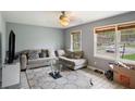 Bright living room showcasing a comfortable couch, large windows, and an inviting atmosphere at 4329 Cedar Valley Ln, Conley, GA 30288