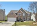 Lovely two-story home with stone facade, well-kept lawn, attached garage, and inviting curb appeal at 2277 Shady Maple Trl, Loganville, GA 30052