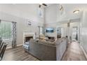 Bright living room with a fireplace, vaulted ceilings, and large windows at 2277 Shady Maple Trl, Loganville, GA 30052