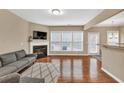 Bright living room with hardwood floors, a fireplace, and large windows offering ample natural light at 4125 Madison Bridge Dr, Suwanee, GA 30024
