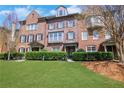Beautiful brick townhouse showcasing a lush green lawn and traditional design elements at 552 Micayne Se Cir # 1, Smyrna, GA 30082