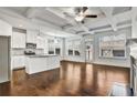 Spacious living area with a modern kitchen island, fireplace, coffered ceilings and hardwood flooring at 2240 Mulsanne Dr, Lithonia, GA 30058