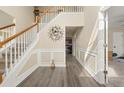 Welcoming foyer with hardwood floors, elegant staircase, and decorative wall accents at 552 Trotters Ln, Mcdonough, GA 30252