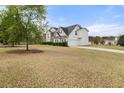Two-story home with an attached garage and a well-maintained, spacious yard and driveway at 552 Trotters Ln, Mcdonough, GA 30252