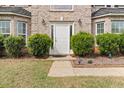 Charming entrance featuring a classic white door with sidelights and manicured landscaping at 552 Trotters Ln, Mcdonough, GA 30252