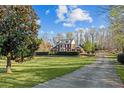 Beautiful brick home, featuring a lush lawn and a winding driveway at 168 Jersey Rd, Oxford, GA 30054
