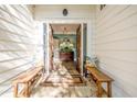 Inviting entryway with wooden benches, stone flooring, and antique console table with decorative lamps at 202 Lakeview Ave, Atlanta, GA 30305