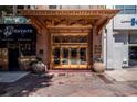 An ornate building entrance with decorative gold accents, planters, and historical signage at 32 Peachtree Nw St # 1303, Atlanta, GA 30303