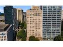 An exterior view of a tall building surrounded by other skyscrapers and greenery at 32 Peachtree Nw St # 1303, Atlanta, GA 30303