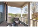 Relaxing porch view overlooking lush greenery and a serene landscape, perfect for enjoying the outdoors at 4514 Heathrow Nw Ct, Kennesaw, GA 30152
