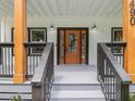 Close-up of front porch showing decorative glass in the front door and black trimmed windows at 490 Third Ave, Scottdale, GA 30079