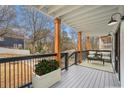 Relaxing outdoor porch with seating, potted plants, and black metal railing at 490 Third Ave, Scottdale, GA 30079