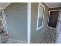 Close-up of entrance with gray painted wood and white trim details at 1005 Berkeley Woods Dr, Duluth, GA 30096