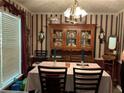 Elegant dining room with vintage-inspired decor and a large hutch for displaying fine china and decor at 1109 Granite Ln, Loganville, GA 30052