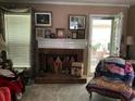 Inviting living room featuring a brick fireplace, creating a warm and comforting space for relaxation and gatherings at 1109 Granite Ln, Loganville, GA 30052