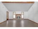 Bright living room features a stone fireplace, wood beam ceiling and hardwood floors at 2243 Provence Ne Ct, Marietta, GA 30066