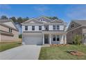 Charming two-story home with white painted brick, complemented by a well-maintained lawn and landscaping at 616 Leafy Branch Way, Mcdonough, GA 30253