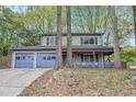 Charming two-story home featuring a covered porch and two-car garage at 835 Ridge Ave, Stone Mountain, GA 30083
