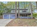 Inviting two-story home with a covered front porch and a convenient two-car garage at 835 Ridge Ave, Stone Mountain, GA 30083
