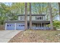 Traditional two-story home with a covered porch and a two-car garage at 835 Ridge Ave, Stone Mountain, GA 30083
