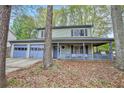Inviting home with a covered porch and attached two-car garage at 835 Ridge Ave, Stone Mountain, GA 30083