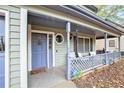 Close-up of a welcoming front porch with charming lattice railings and a decorative front door at 835 Ridge Ave, Stone Mountain, GA 30083