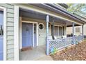 Cozy covered front porch with seating area and decorative railing at 835 Ridge Ave, Stone Mountain, GA 30083