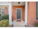 Inviting front entrance with a brick surround, classic door, and decorative columns at 184 Chamberlyn Ln, Hiram, GA 30141