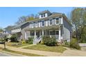 Two-story home featuring a charming front porch with white railing and beautifully maintained landscaping at 2241 Harry Brooks Nw Dr, Atlanta, GA 30318