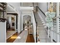 Inviting foyer with hardwood floors, staircase, and views into the living room, offering a warm welcome at 2241 Harry Brooks Nw Dr, Atlanta, GA 30318