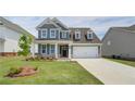 Beautiful two-story home featuring manicured lawn, brick accents, and two-car garage at 255 Arnewood Cir, Mcdonough, GA 30253
