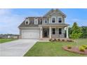 Beautiful two-story home featuring a covered porch, an attached garage, and manicured front yard at 255 Arnewood Cir, Mcdonough, GA 30253