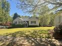 Traditional-style house with neat landscaping and a well-kept lawn creating a welcoming curb appeal at 262 Bomar Ln, Douglasville, GA 30134