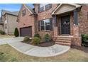 Inviting entryway with a brick walkway, decorative wreath, and a charming 