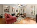 Bright living room with a fireplace, built-in shelves, and a door to the outside at 4900 Fairmont Way, Roswell, GA 30075