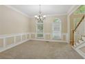 Formal dining room with neutral walls, carpeted floors, and elegant lighting for memorable gatherings at 100 Julia Ct, Fayetteville, GA 30214