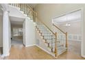 Elegant staircase with carpeted steps and hardwood floors in the entry, leading to the upper level at 100 Julia Ct, Fayetteville, GA 30214