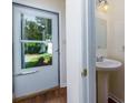 Powder room with pedestal sink and view to front door and lawn at 137 Venture Path, Hiram, GA 30141