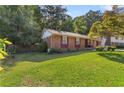 Well-kept single-story brick home with a spacious lawn, ideal for outdoor enjoyment at 37 Crystal River Dr, Riverdale, GA 30274