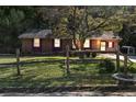 Quaint single-story brick home with a fenced yard, mature tree, and mailbox at 37 Crystal River Dr, Riverdale, GA 30274